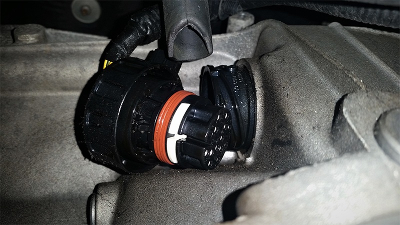 Disconnect the Mechatronic electrical connector by rotating the connector locking ring counterclockwise. Position the connector out of the way to access the connector sleeve.